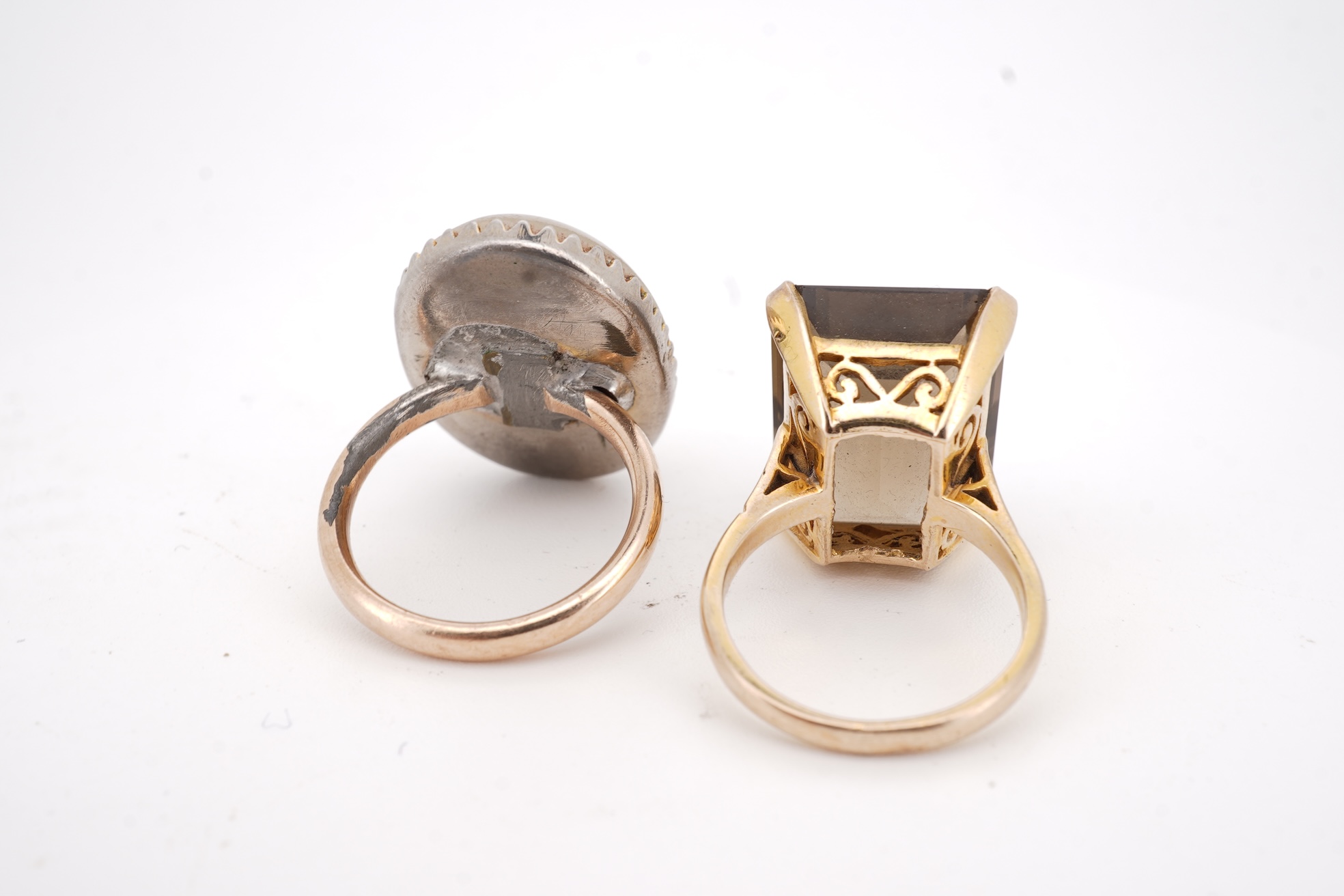 A modern 9ct gold and single stone emerald cut smoky quartz set ring, size N and one other 1960's 9ct gold shank, with a later added agate set white metal mount.